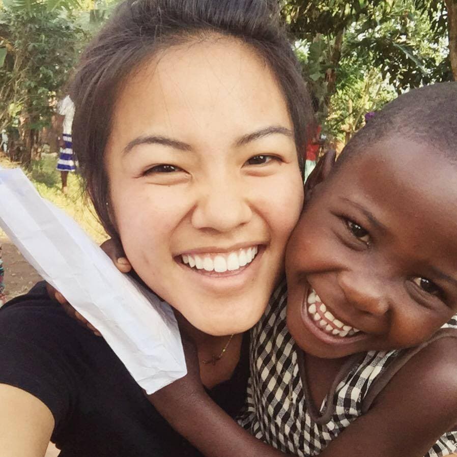 Loving One by One Ministries volunteer embracing a child
